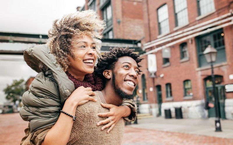 a man carrying a woman