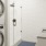 a room with a washing machine and a plant